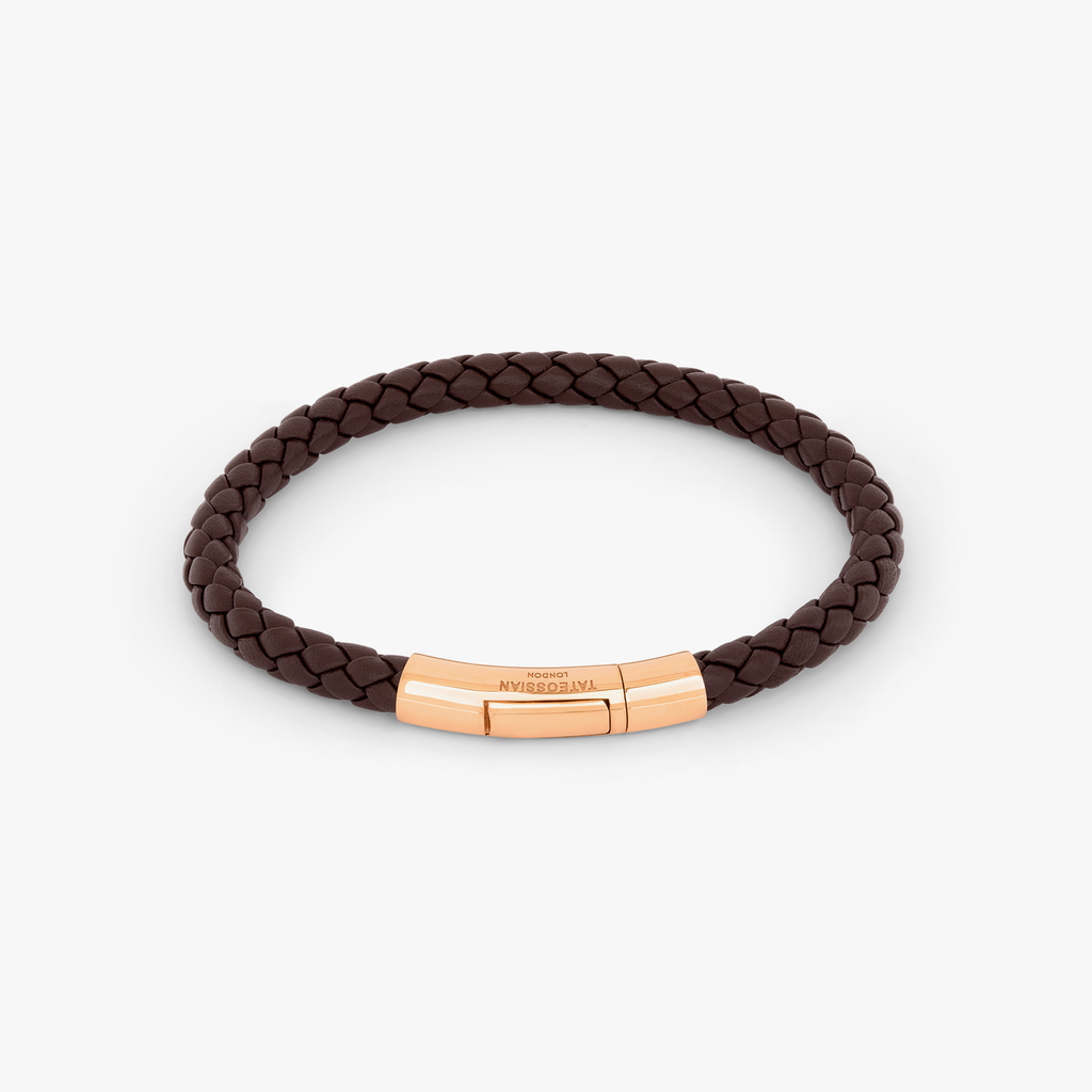 A brown leather bracelet with a rose gold clasp, hand-wrapped in a classic braid design. 18k Rose Gold 
