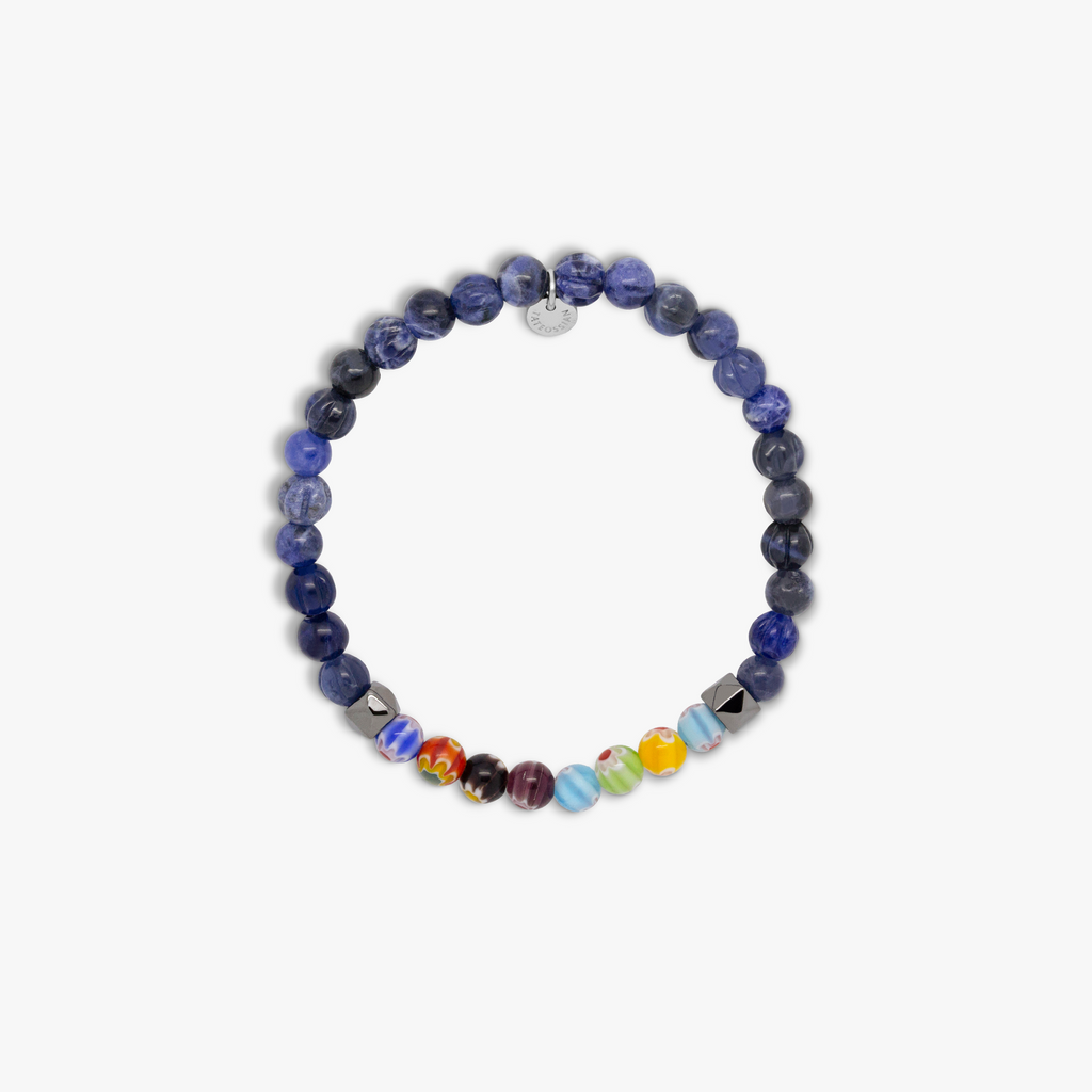 A multicolored beaded bracelet with blue sodalite and millefiori design, strung on an elastic band.