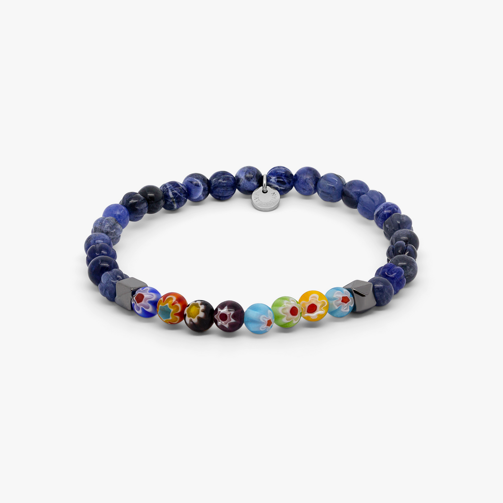 A multicolored beaded bracelet with blue sodalite and millefiori design, strung on an elastic band.