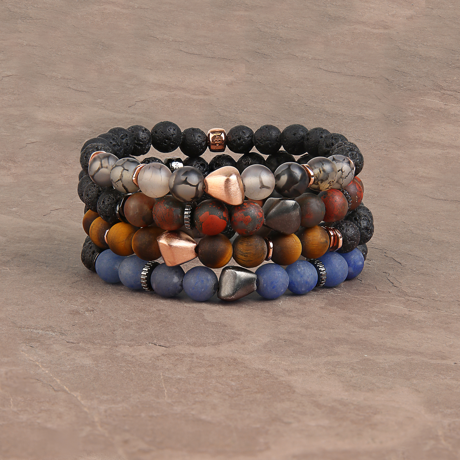 A bracelet featuring a mix of frosted fire agate and raw volcanic lava beads, with rose gold-coloured sterling silver detailing.