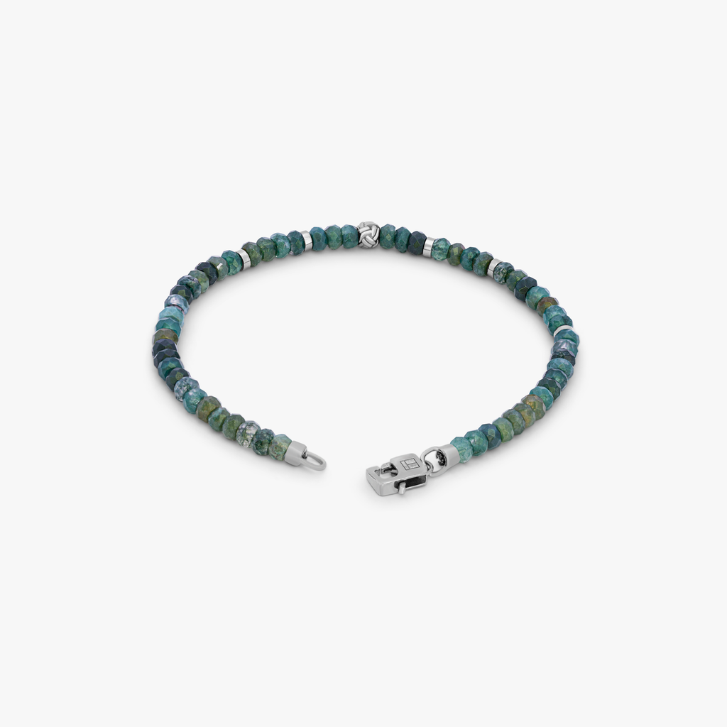 A beaded bracelet with green moss agate beads and silver accents, finished with a rhodium silver knot bead and a matching lobster clasp.