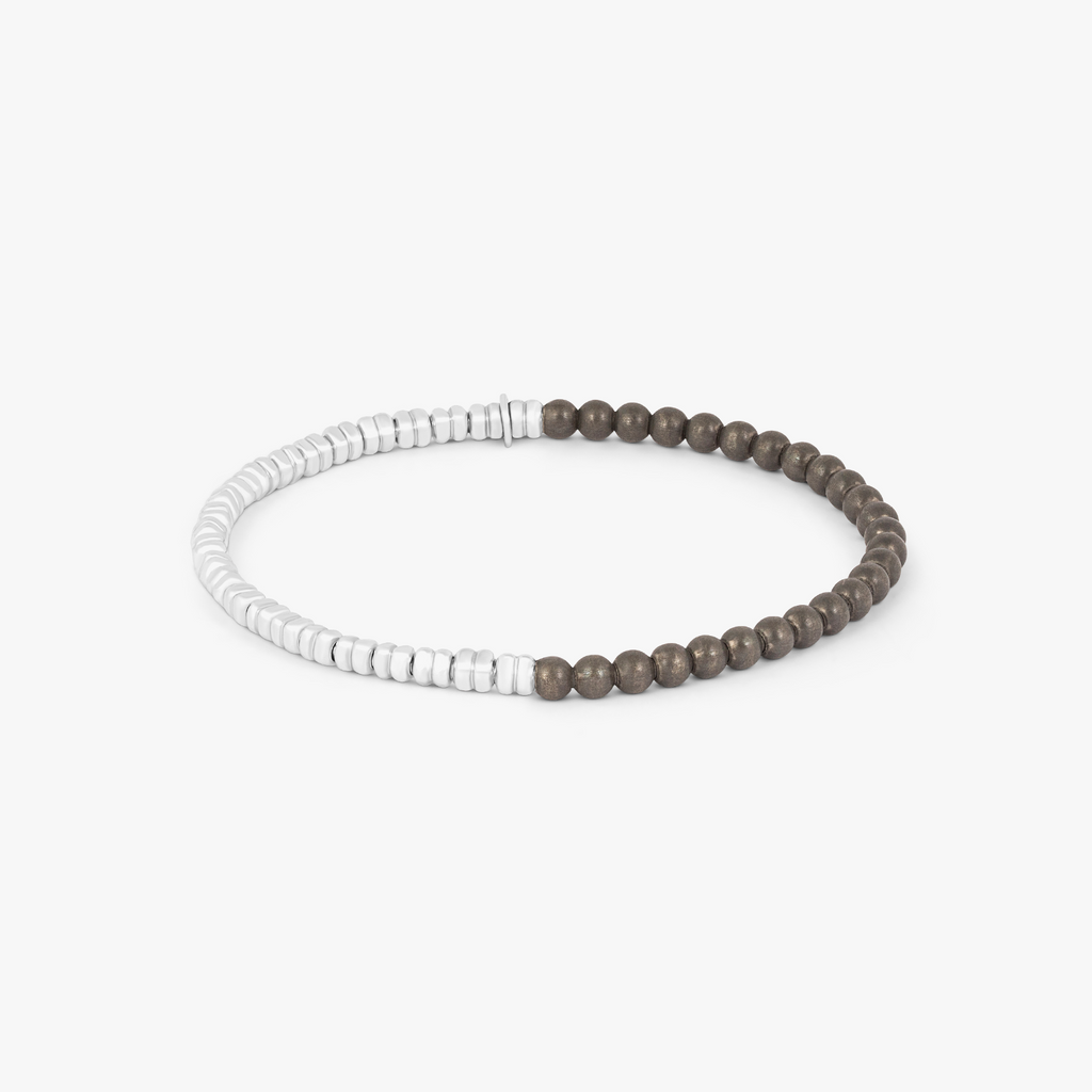 A bracelet with a combination of silver and grey titanium beads, featuring a half moon shape and a Tateossian gear tag.