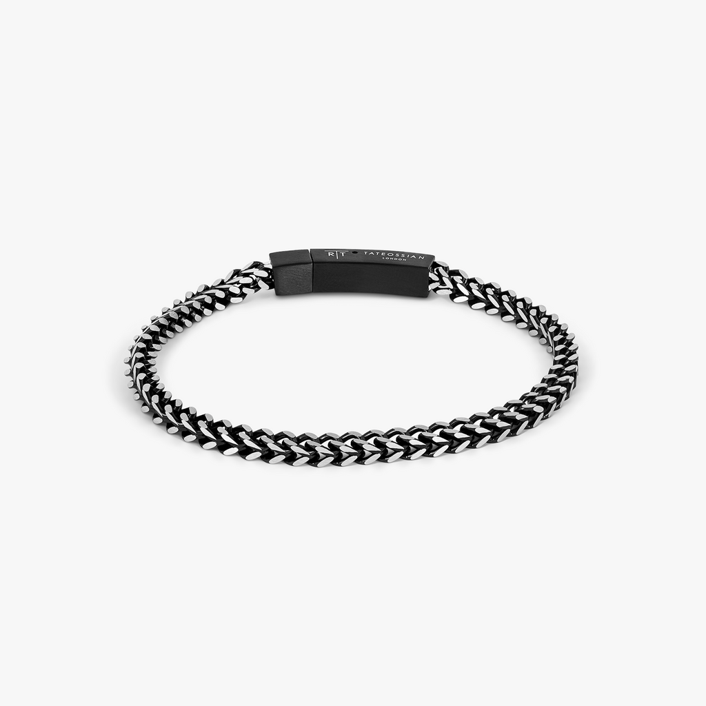 Chevron Click Bracelet In Matte Black featuring chevron-patterned black stainless steel chain with matte black clasp.