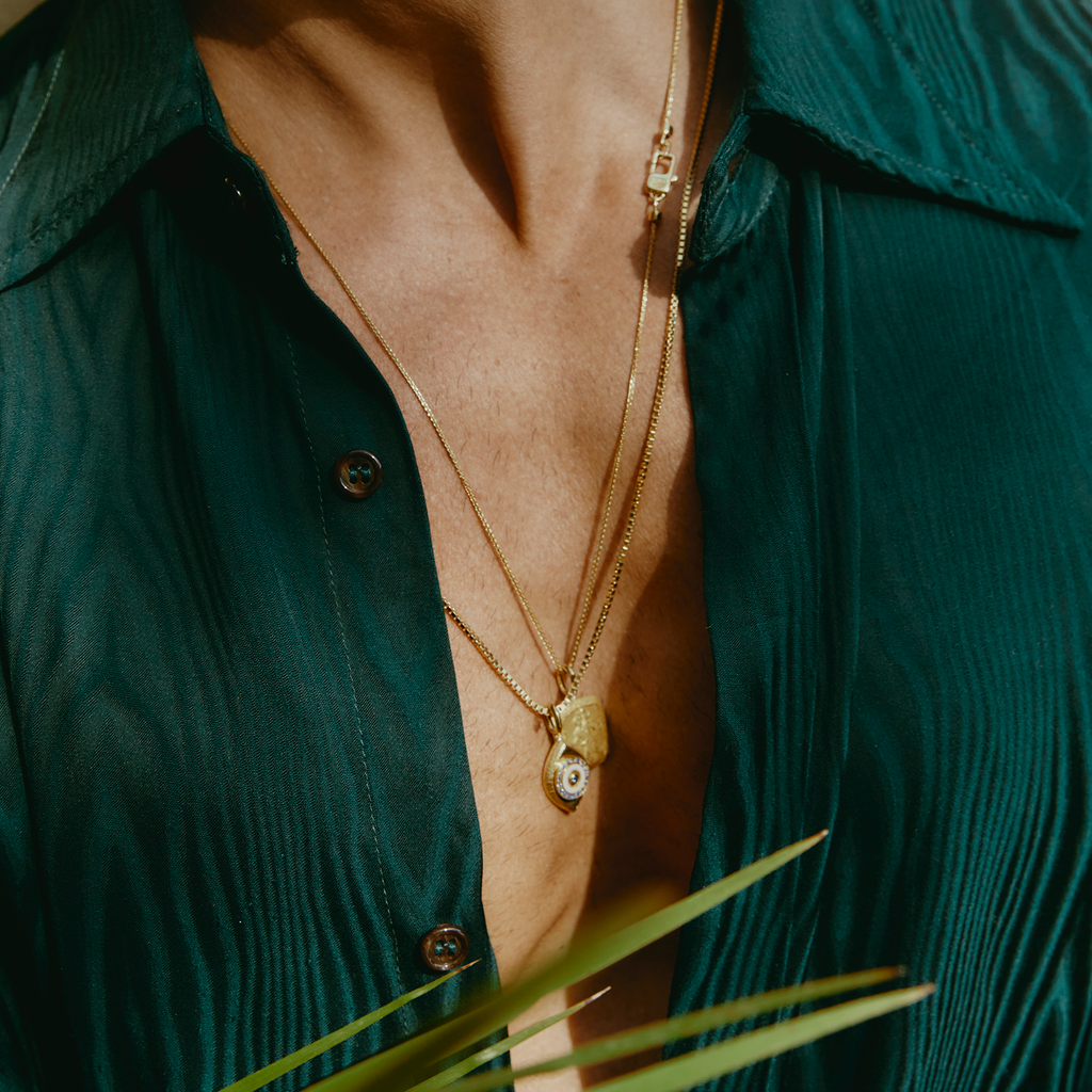 Paros Evil Eye necklace in yellow gold plating with sapphire-set iris, white enamel detail, and box chain.