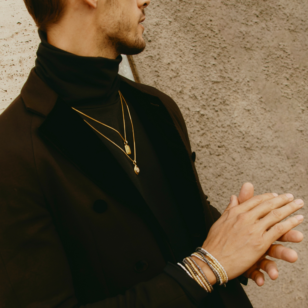 Paros Evil Eye necklace in yellow gold plating with sapphire-set iris, white enamel detail, and box chain.