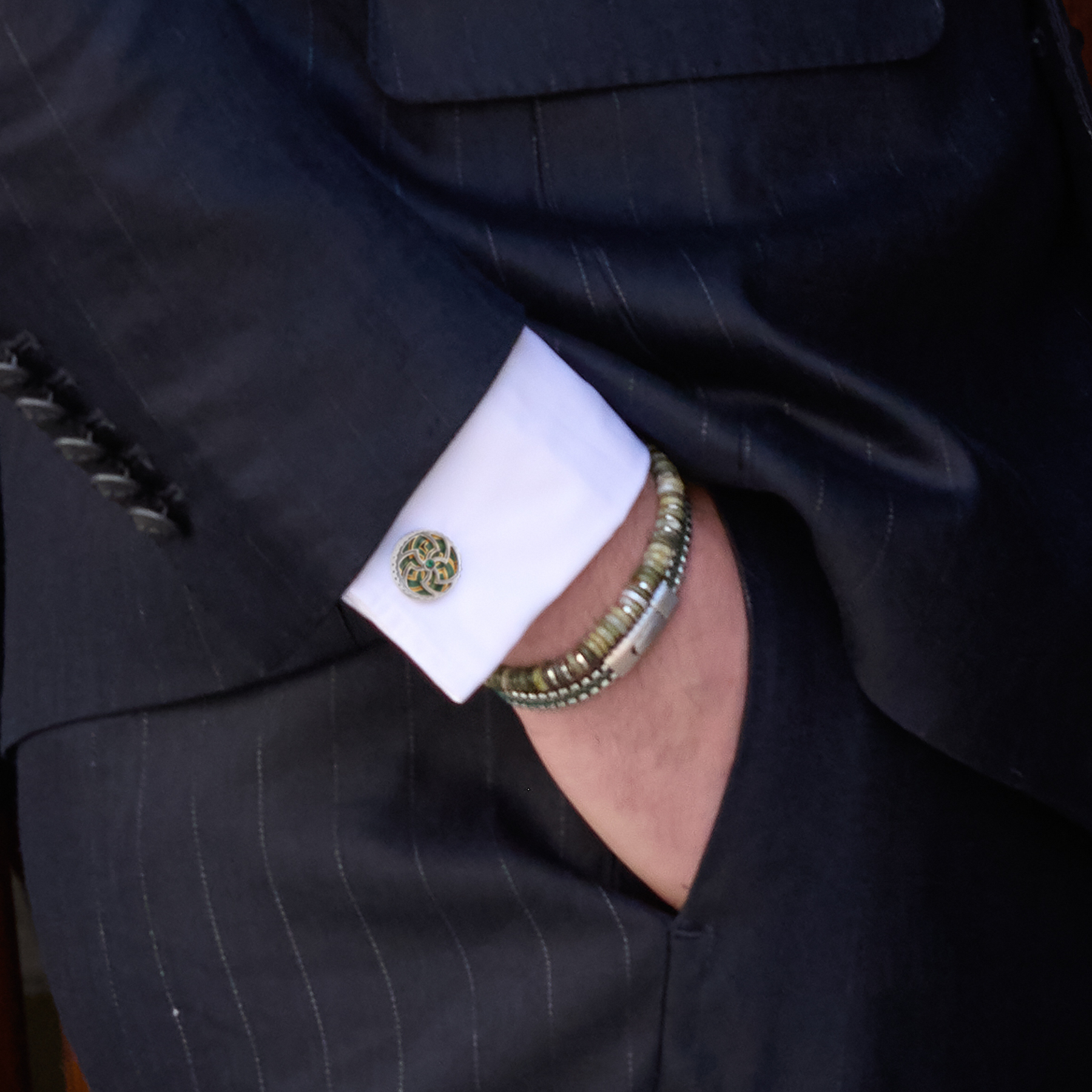 Rotating Trinity cufflinks in green enamel with Swarovski crystal, featuring a rotating Celtic Triskelion and Trinity Knot design in gold and palladium finish.