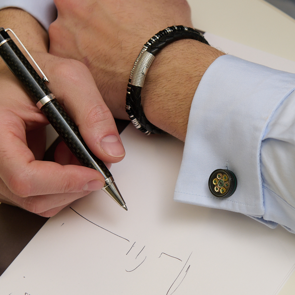 Septa Gear cufflinks in rose and yellow gold tones with grey Alutex, featuring rotating interlocking gears and a central cubic zirconia.