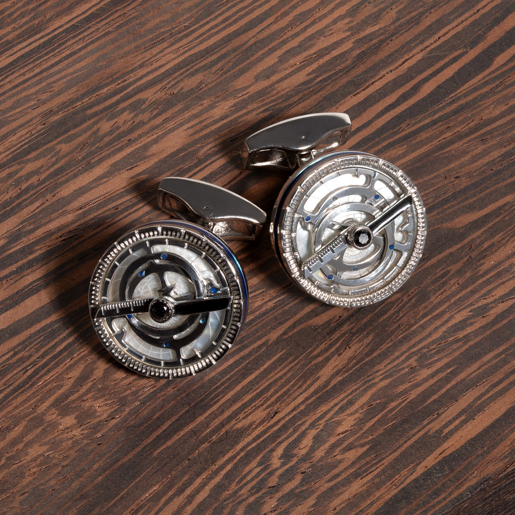 Rotating celestial cufflinks with black and navy enamel accents, Swarovski crystals, and polished metal frame