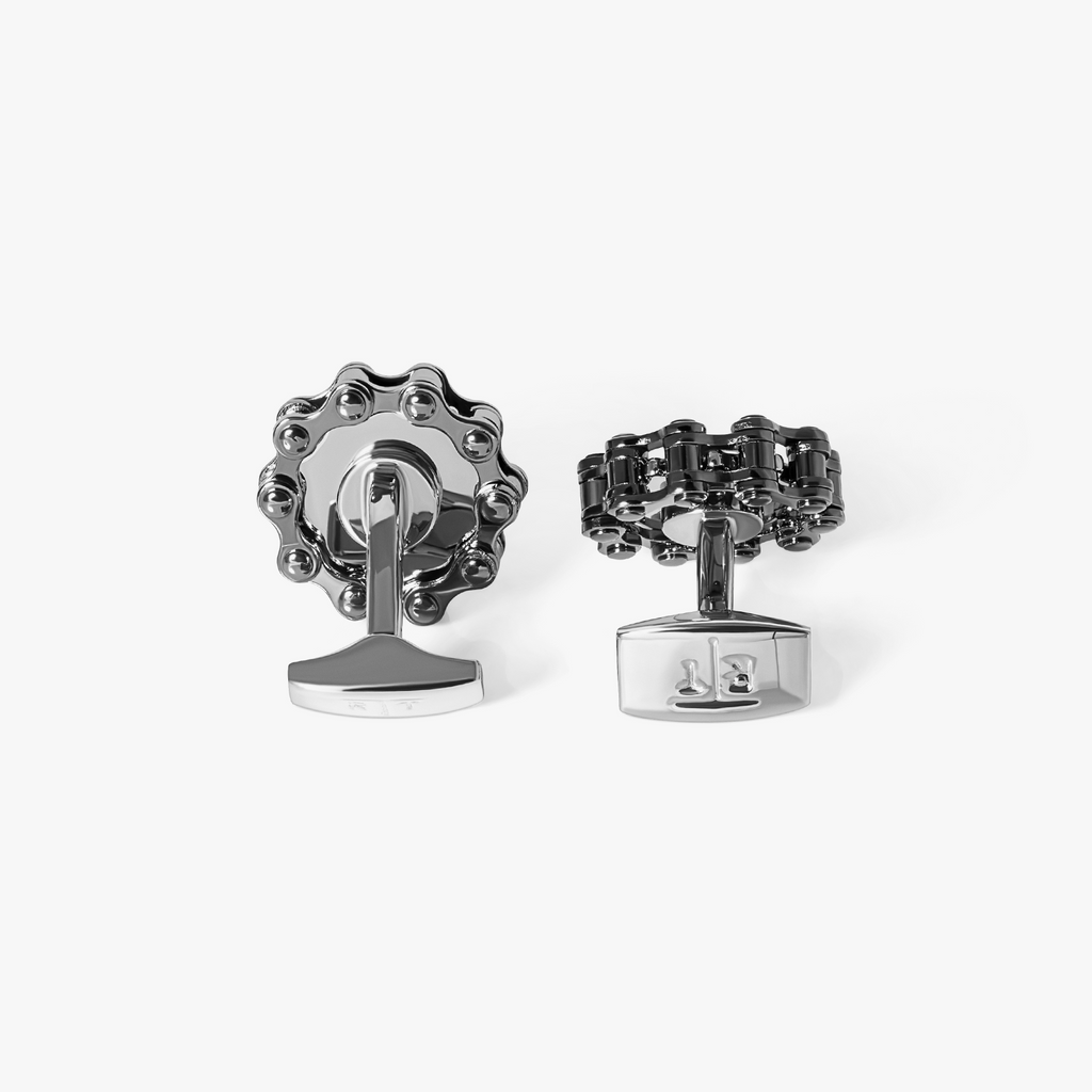 Modern mechanical-style cufflinks featuring interlocking chain links and a polished yellow gold engraved centre