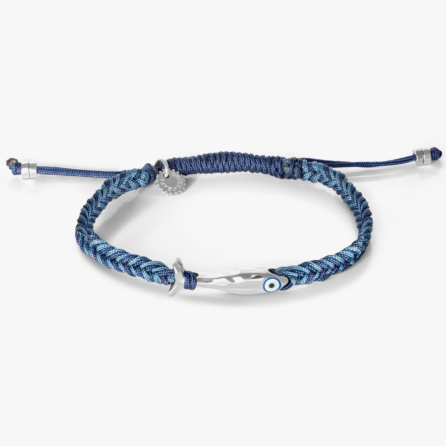 Feng Shui fish macrame bracelet in blue with rhodium-plated sterling silver fish motif, blue enamel evil eye, and braided macramé band.