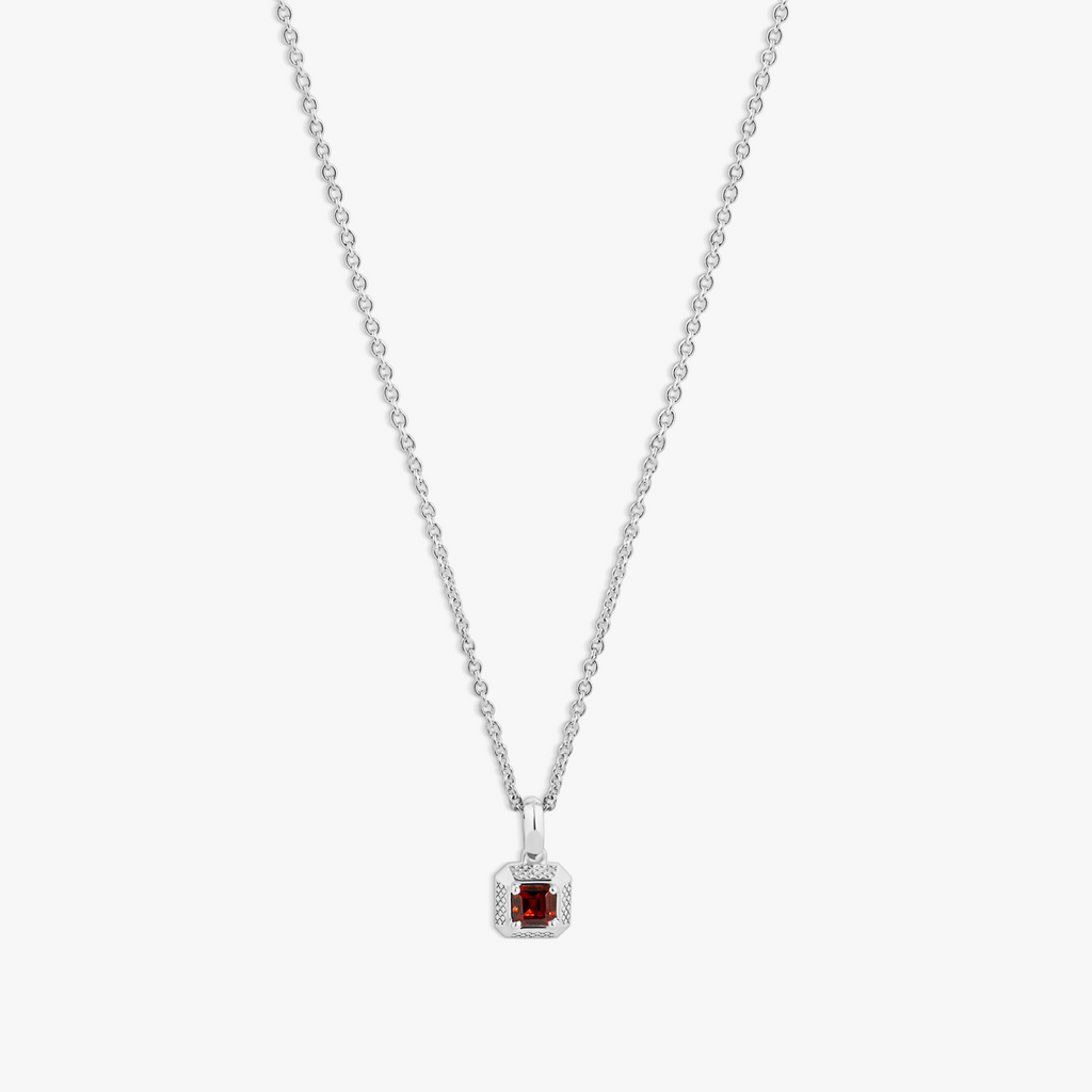 A rhodium-plated sterling silver necklace with a square-shaped pendant featuring a red garnet, set within a polished rounded square frame, with a chain visible in the background.