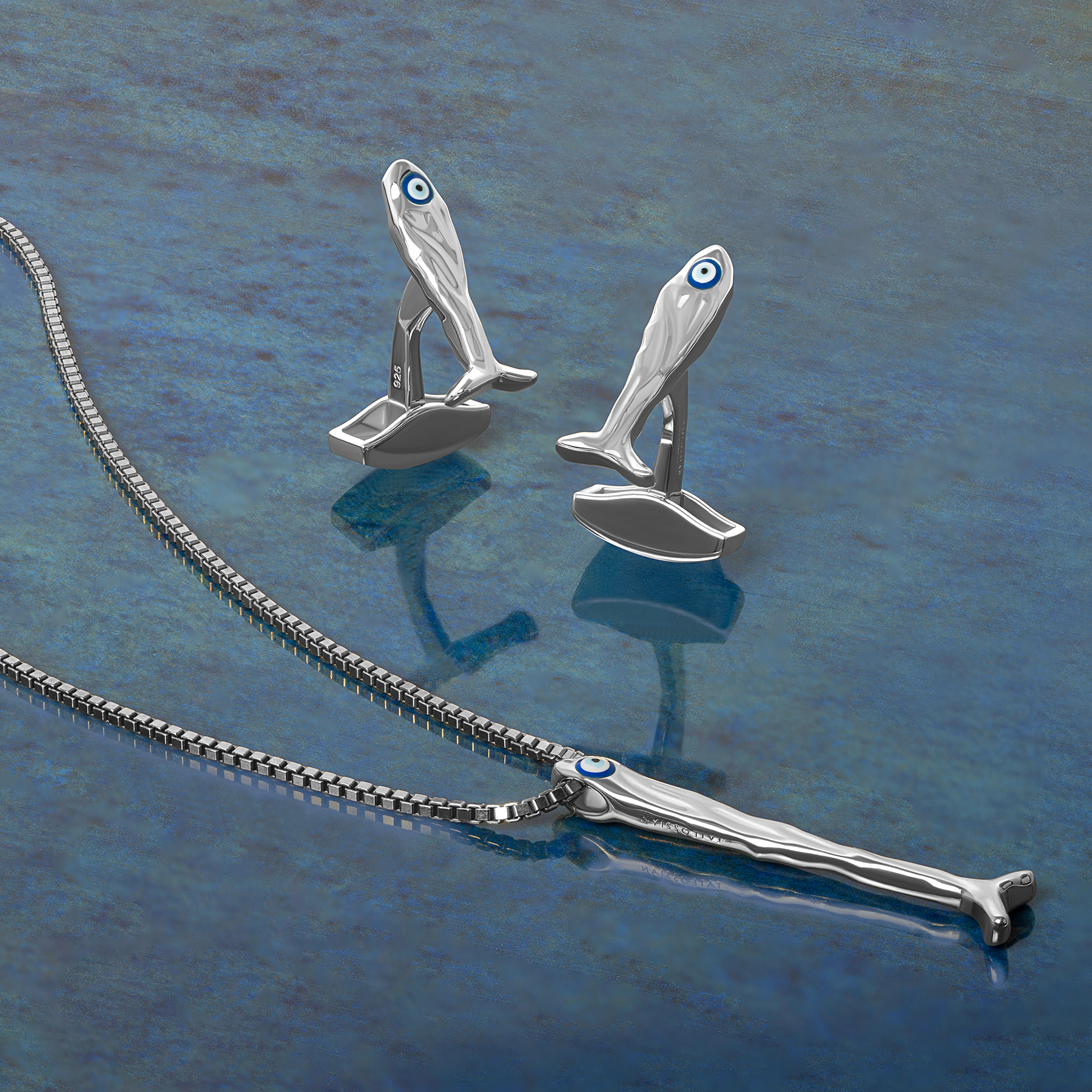Feng Shui fish necklace in sterling silver with blue enamel evil eye pendant on a 1.5mm box chain.