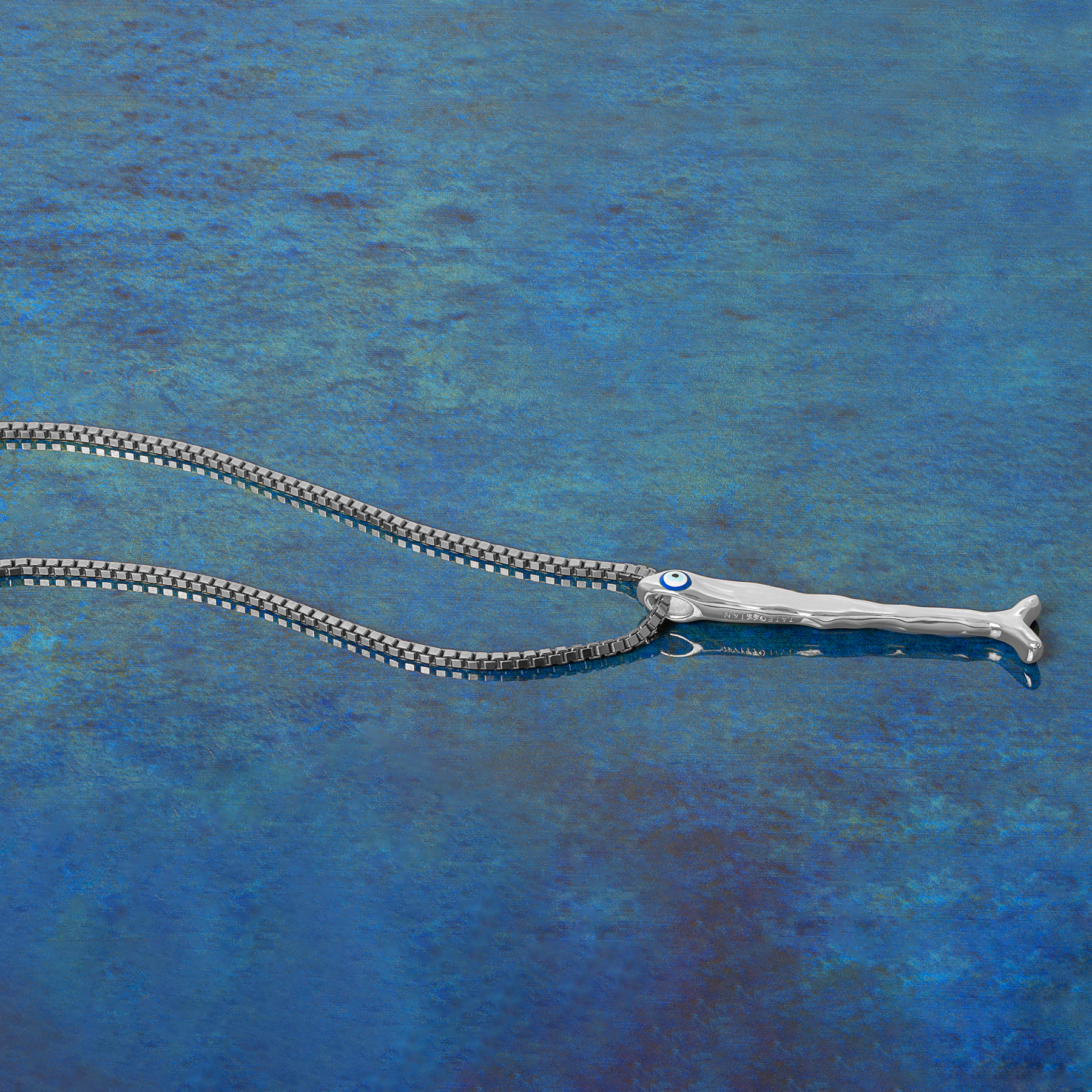 Feng Shui fish necklace in sterling silver with blue enamel evil eye pendant on a 1.5mm box chain.
