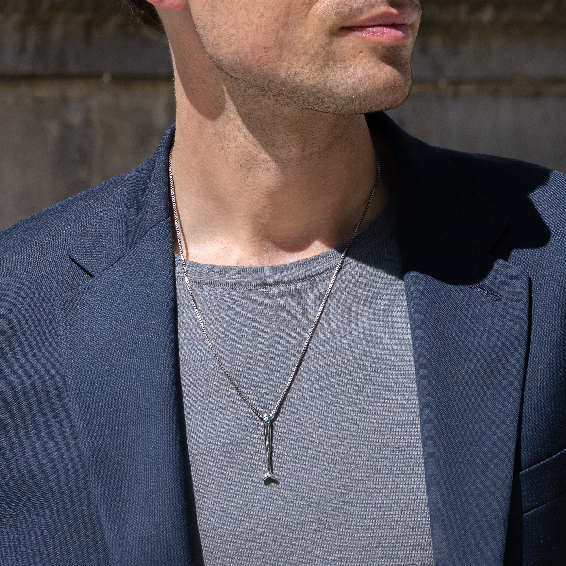 Feng Shui fish necklace in sterling silver with blue enamel evil eye pendant on a 1.5mm box chain.