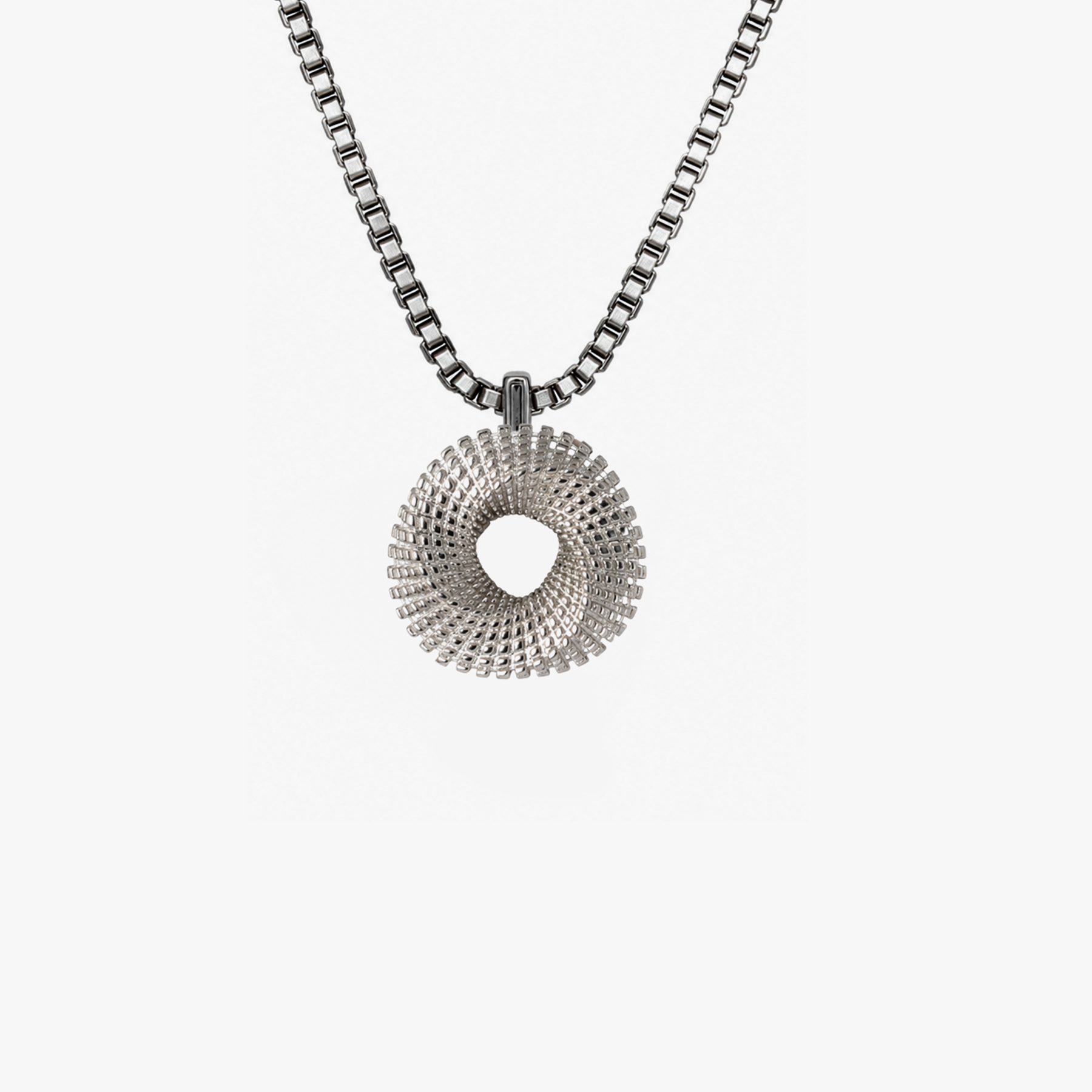 A silver-toned necklace featuring a textured, spiral donut-shaped pendant suspended from a box chain, set against a plain light gray background.