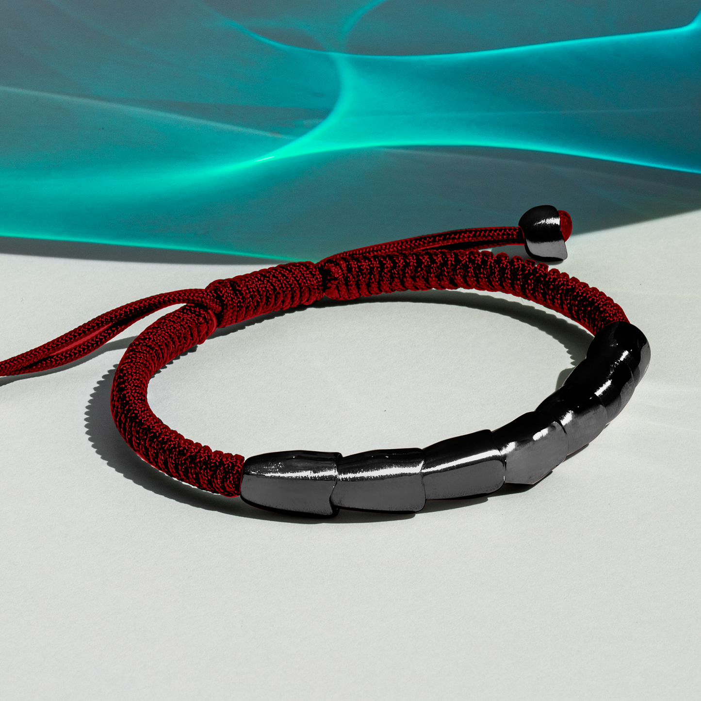 ZAHA HADID DESIGN TORQ MACRAMe BRACELET in brushed Black IP & Burgundy Macrame