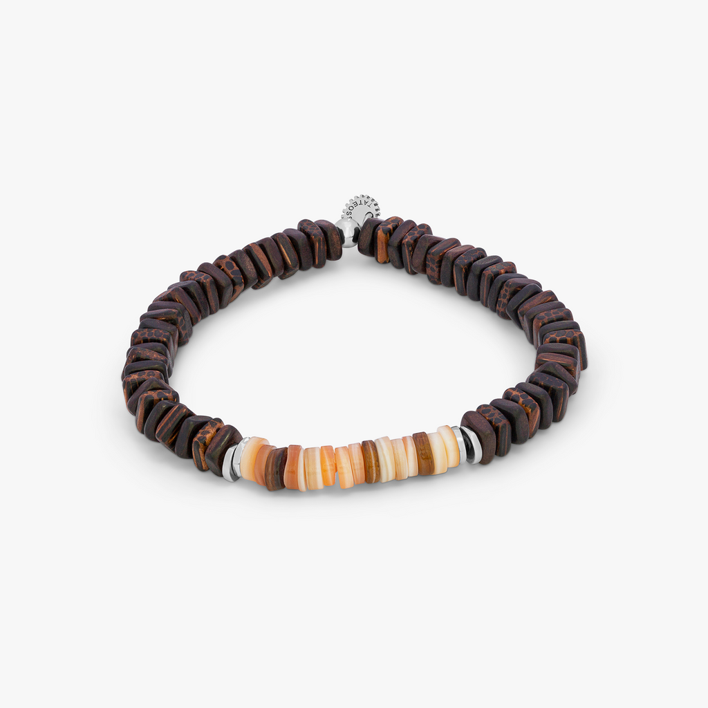 A brown bracelet with a mix of heishi shell and other beads, featuring silver accents.