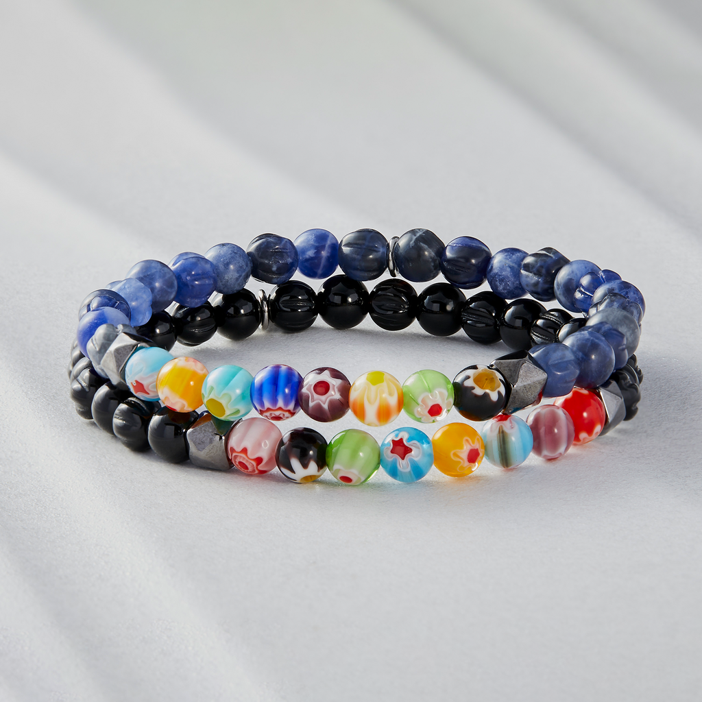 A multicolored beaded bracelet with blue sodalite and millefiori design, strung on an elastic band.