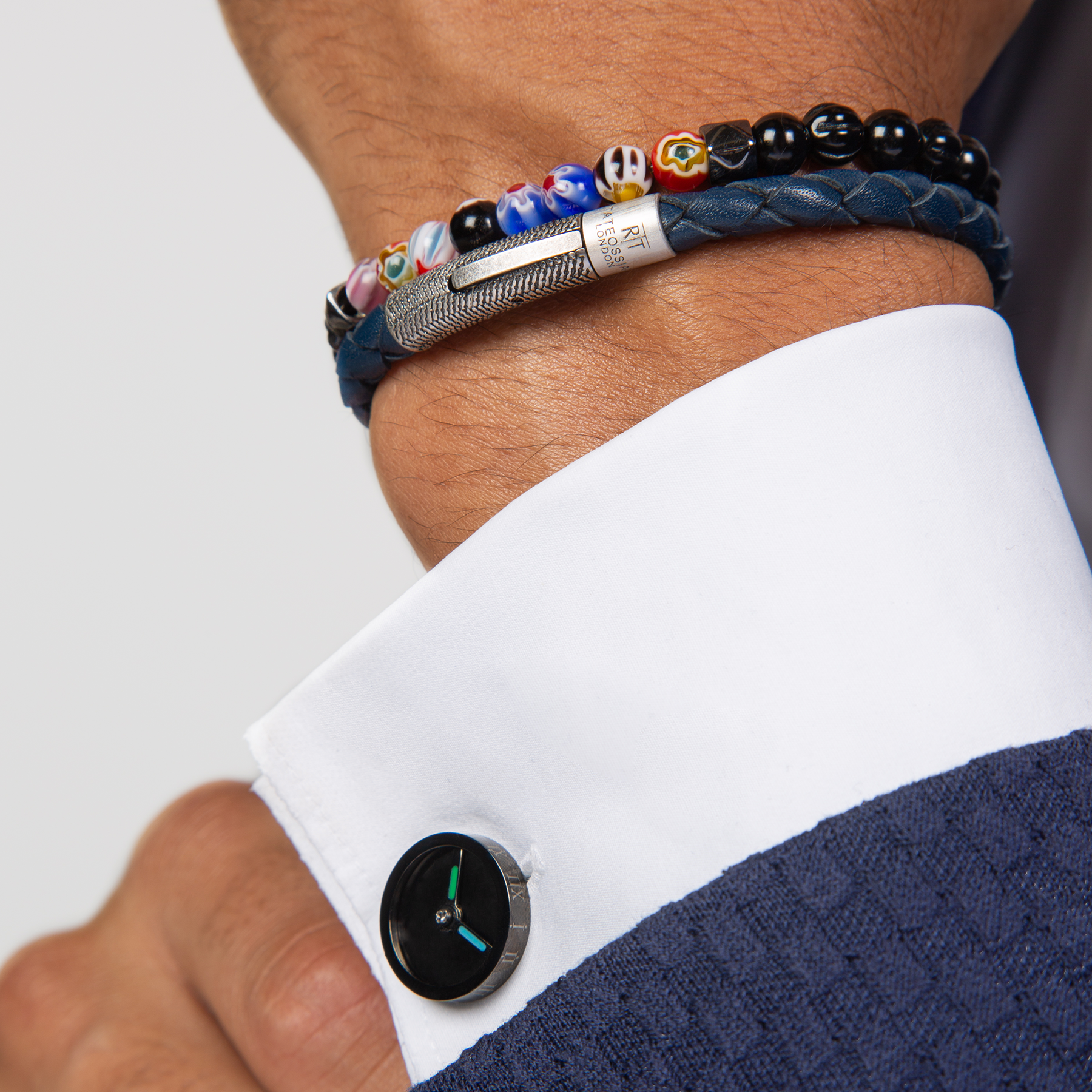 A beaded bracelet with black onyx stones and multicolored beads, showcasing a Millefiori pattern.