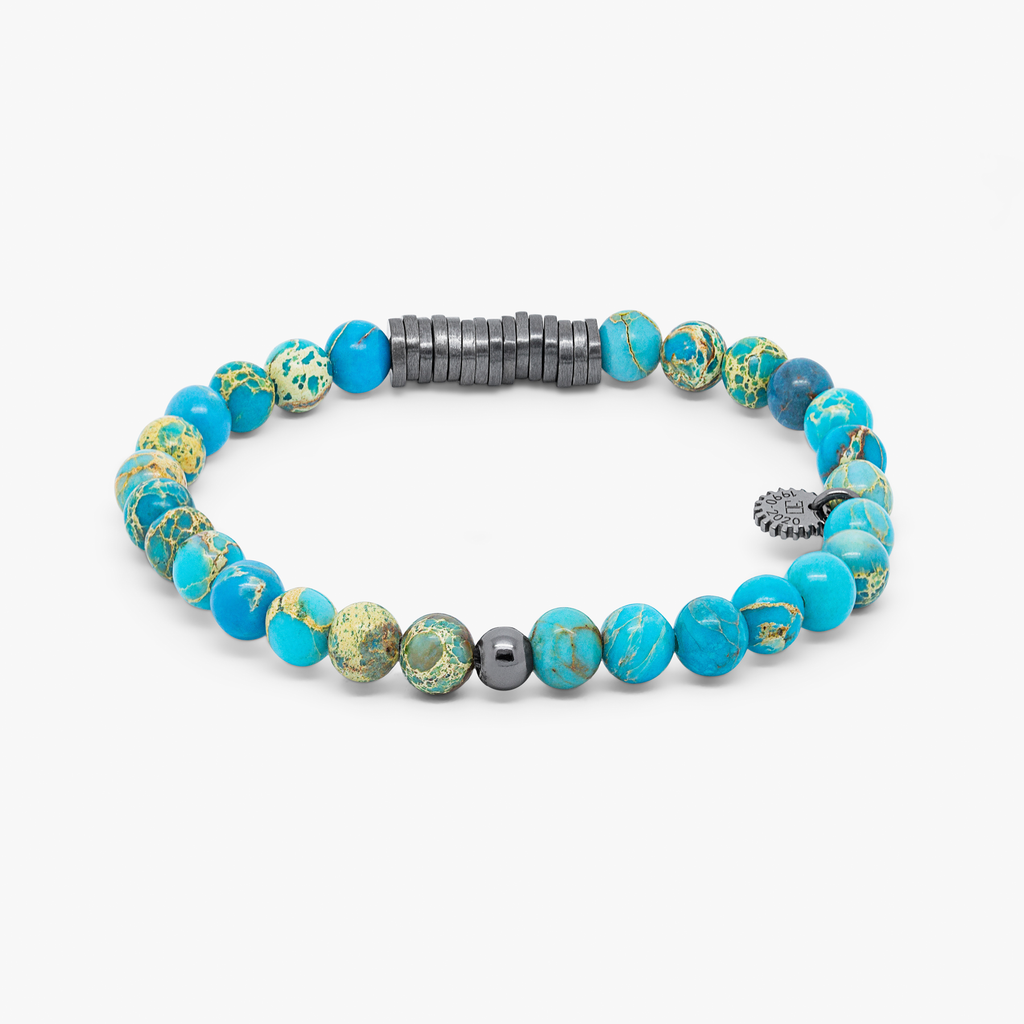 A bracelet with black rhodium plated sterling silver discs and blue Impression Jasper beads, presented against a white background.