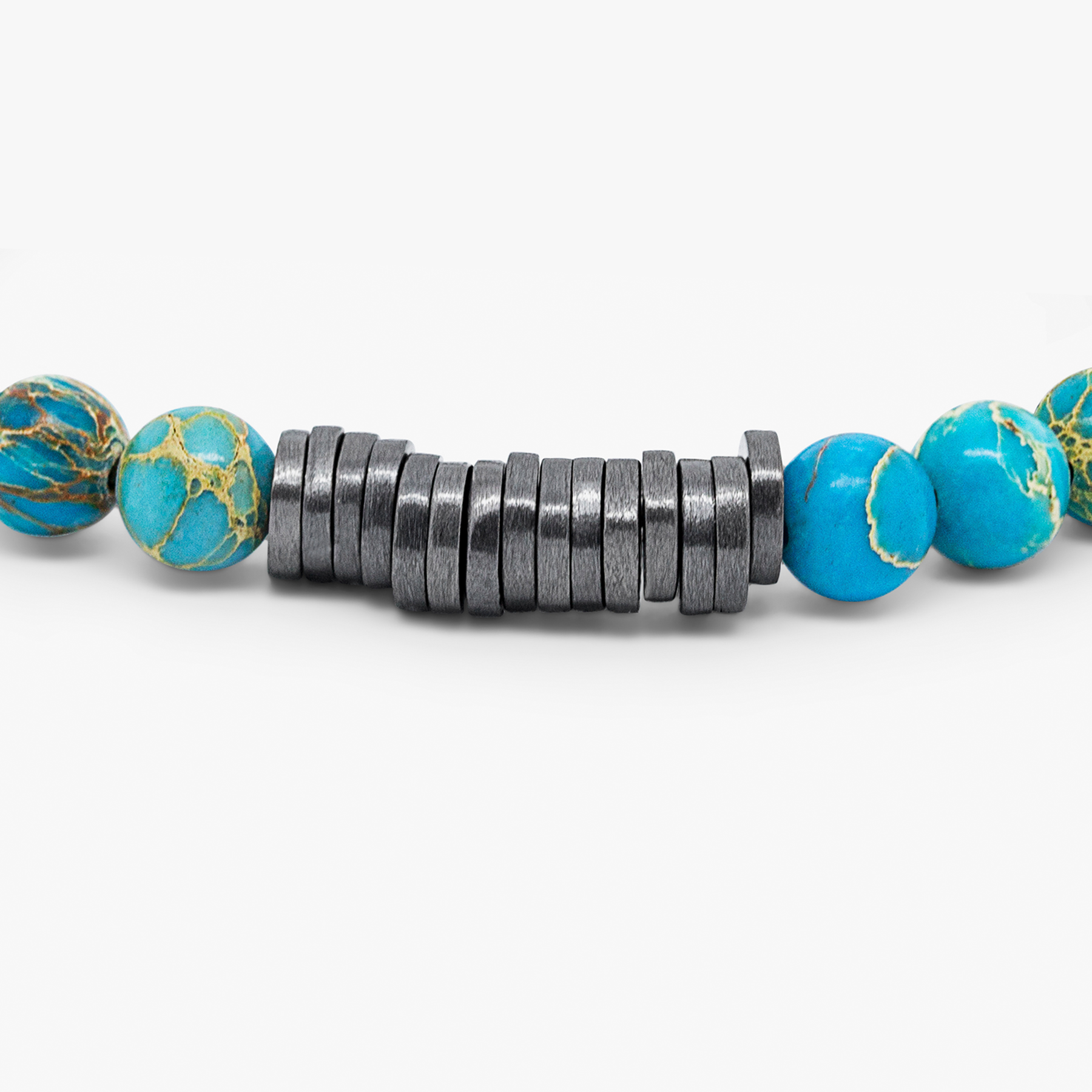 A bracelet with black rhodium plated sterling silver discs and blue Impression Jasper beads, presented against a white background.