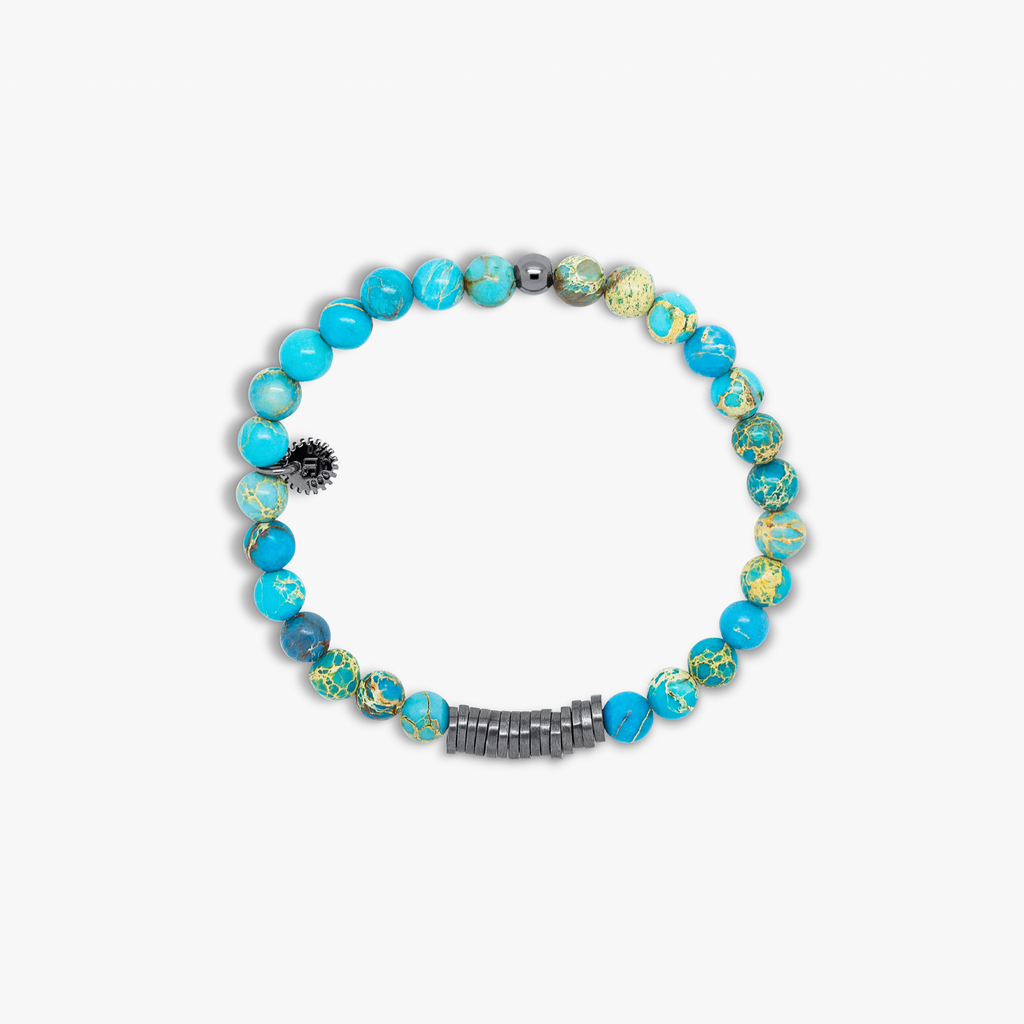 A bracelet with black rhodium plated sterling silver discs and blue Impression Jasper beads, presented against a white background.