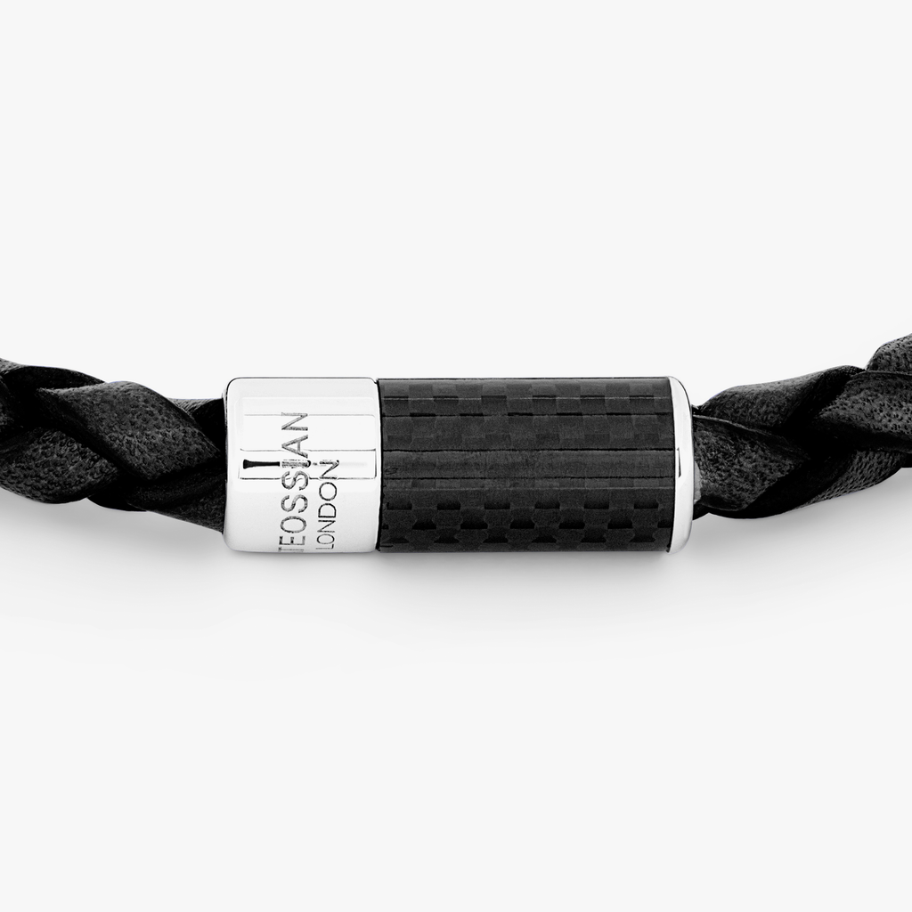 A black leather bracelet with a black carbon fibre clasp, featuring a classic braid design and a 'pop' mechanism clasp.