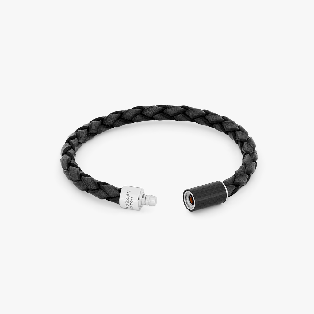 A black leather bracelet with a black carbon fibre clasp, featuring a classic braid design and a 'pop' mechanism clasp.