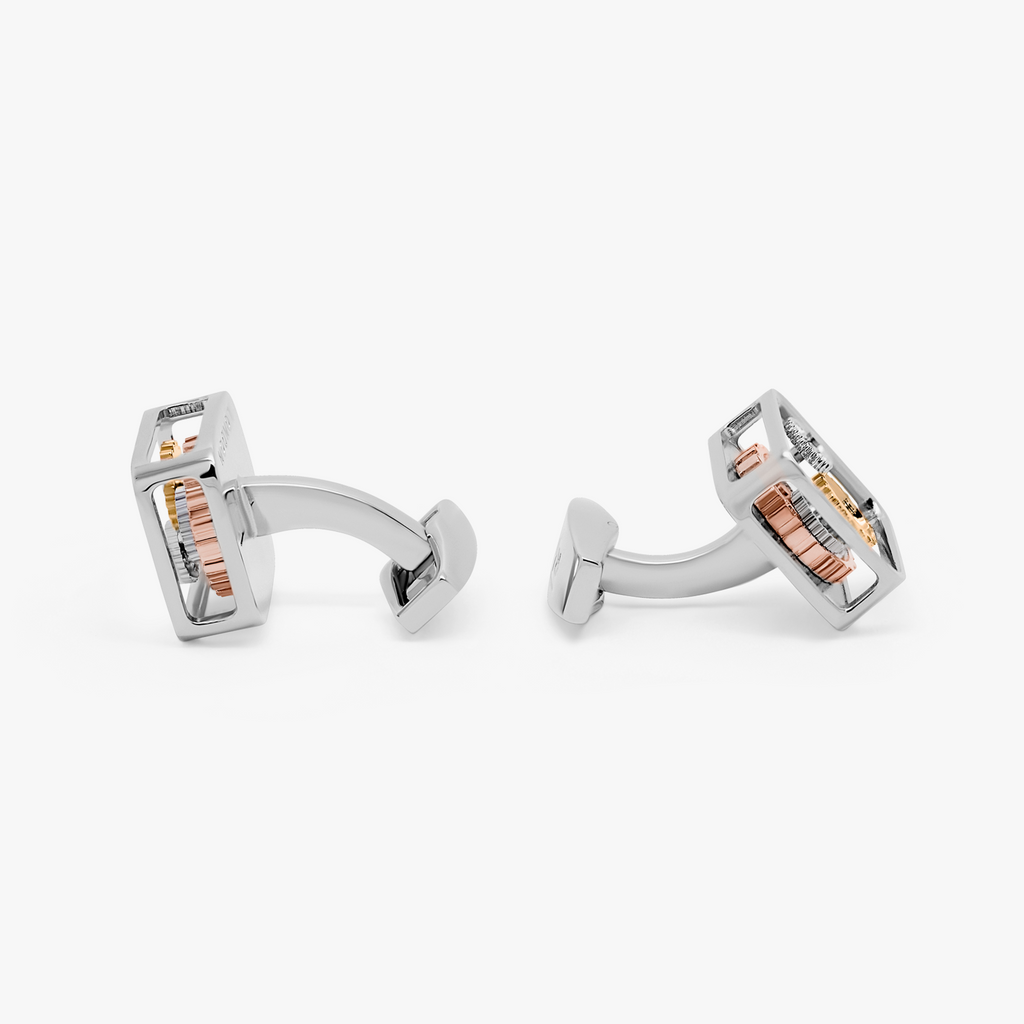 A pair of silver square gear cufflinks with palladium plating and visible mechanical gears inside.