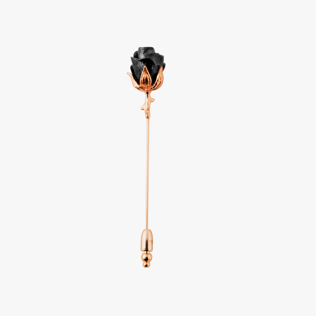 A rose-shaped lapel pin with a black enamel center, rose gold stem, and gunmetal accents.