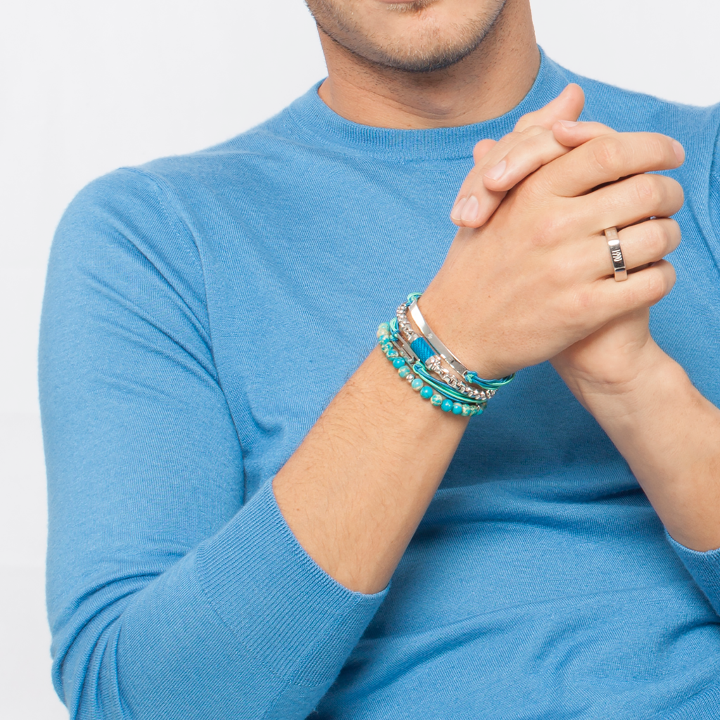 A bracelet with blue Impression Jasper beads and silver-colored discs.