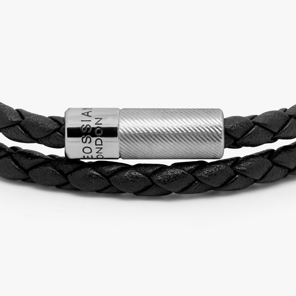 A black leather bracelet with a sterling silver clasp, double wrapped and intricately braided.