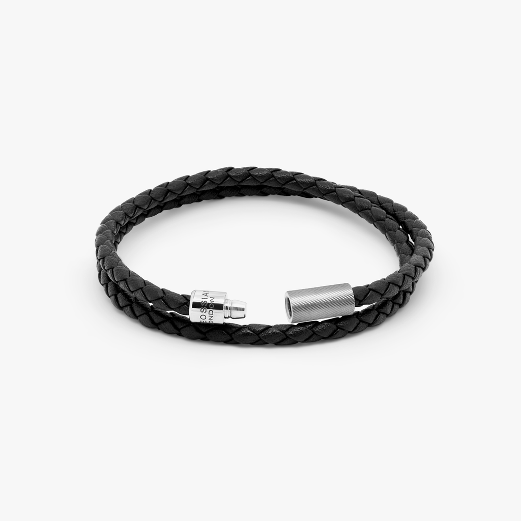 A black leather bracelet with a sterling silver clasp, double wrapped and intricately braided.