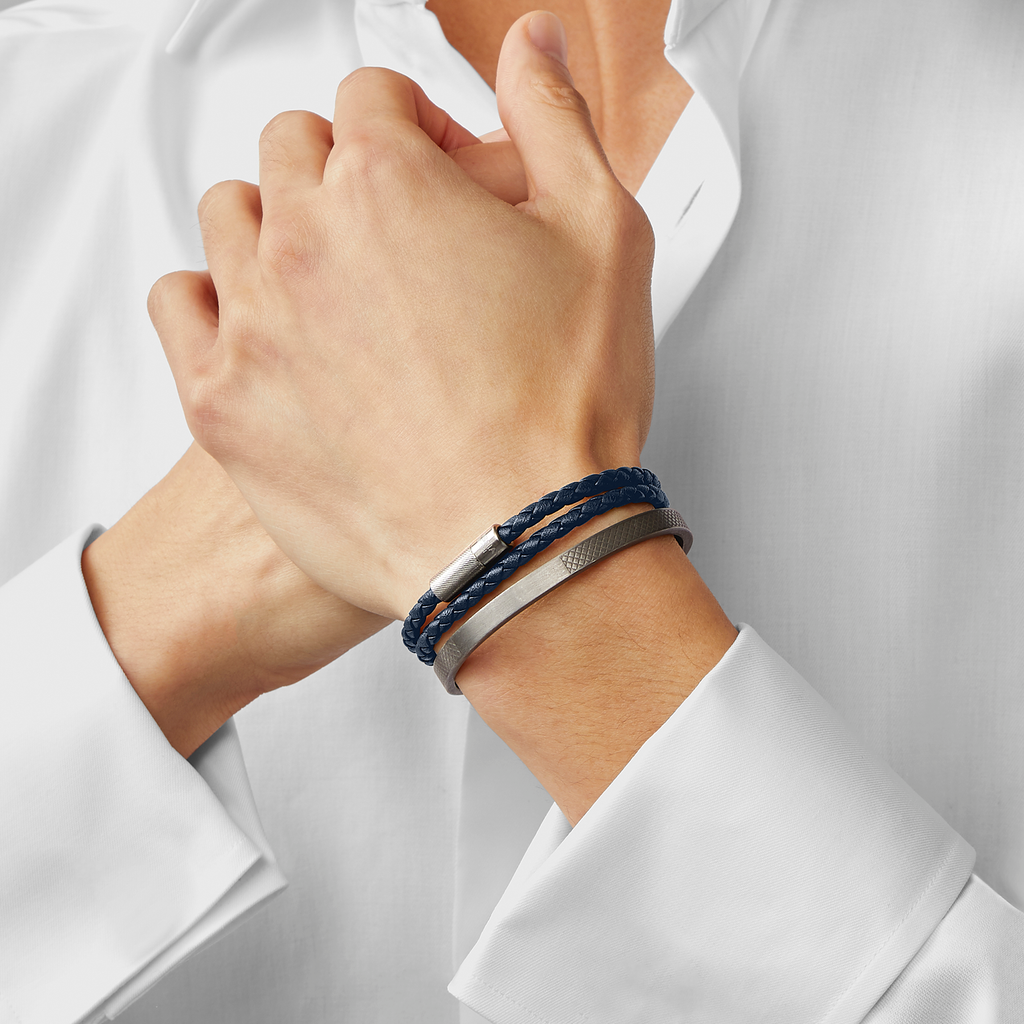 A navy blue double wrap leather bracelet with a sterling silver clasp.