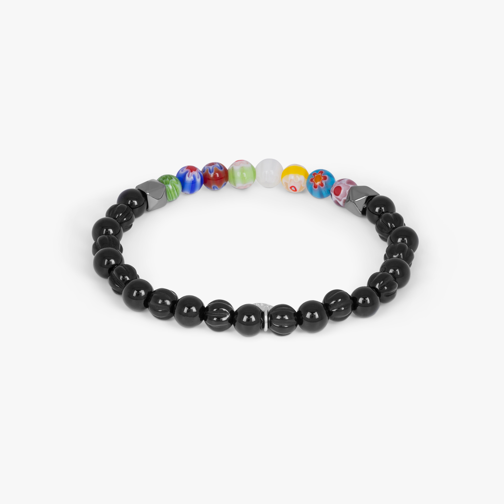 A beaded bracelet with black onyx stones and multicolored beads, showcasing a Millefiori pattern.
