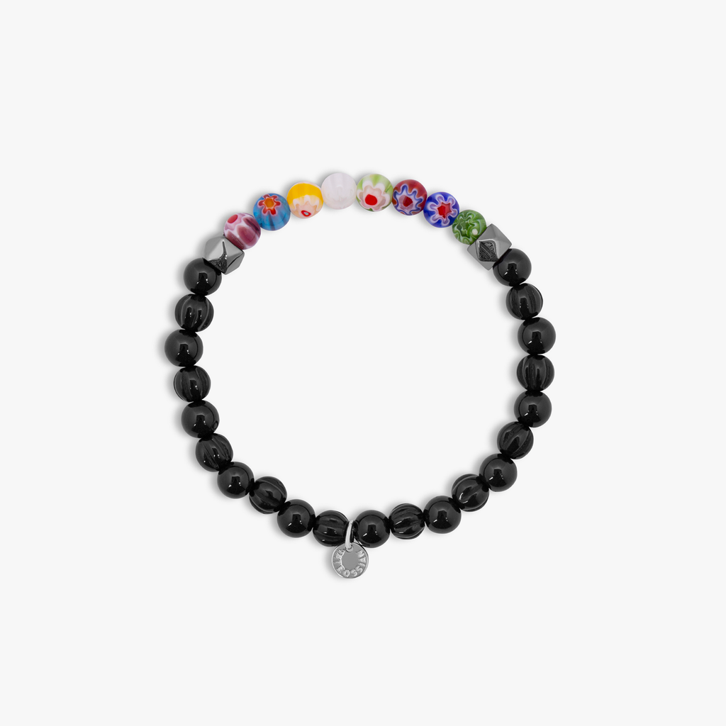 A beaded bracelet with black onyx stones and multicolored beads, showcasing a Millefiori pattern.